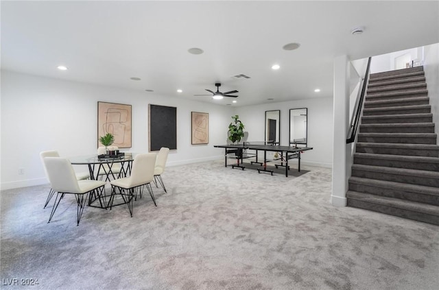 dining room with ceiling fan and light colored carpet