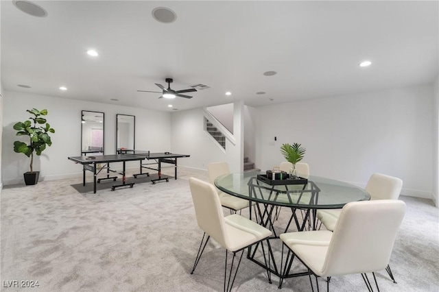 dining area featuring light carpet and ceiling fan