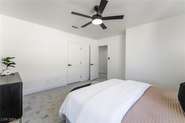 bedroom featuring light carpet and ceiling fan