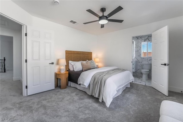 carpeted bedroom with ceiling fan and ensuite bathroom