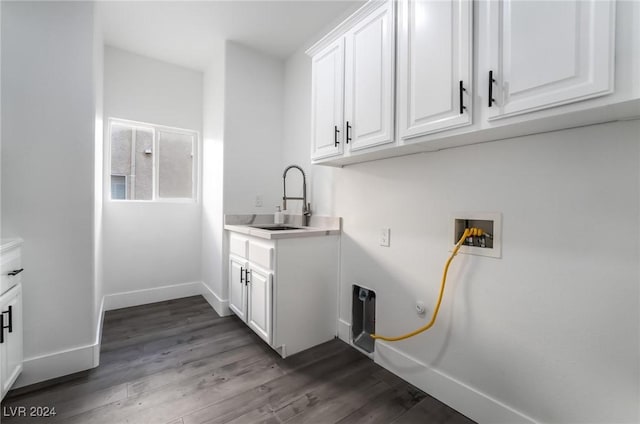 laundry area with cabinets, washer hookup, dark hardwood / wood-style flooring, and sink