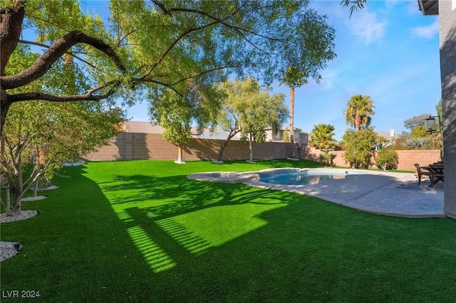 view of yard featuring a patio area and a fenced in pool