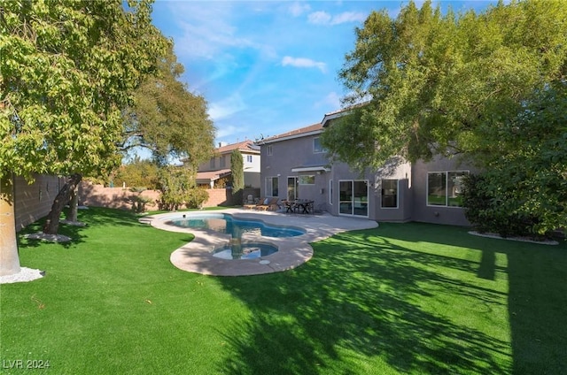 rear view of property featuring a fenced in pool, a yard, and a patio