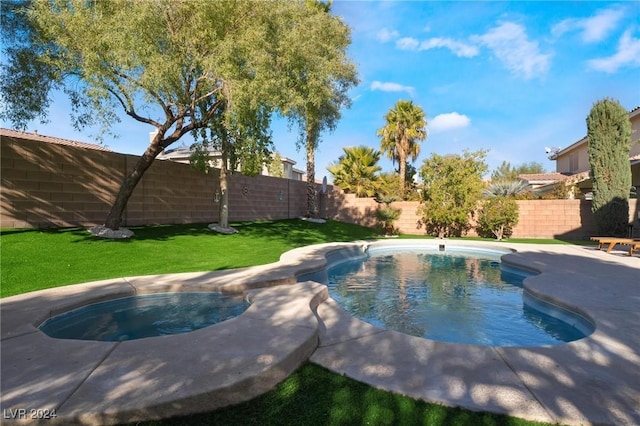 view of pool with a yard