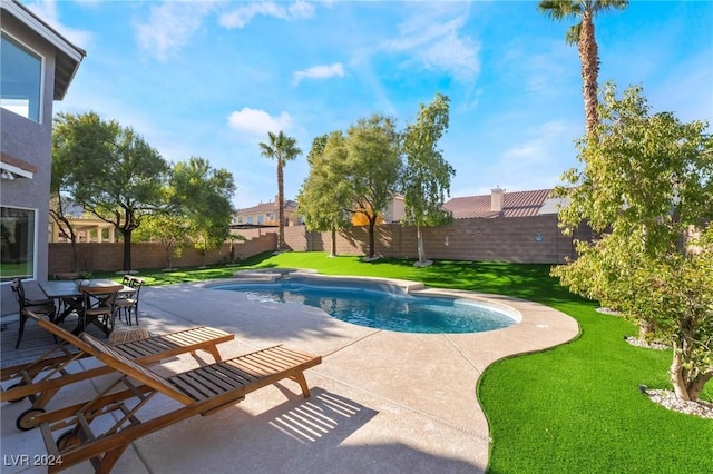 view of pool with a lawn and a patio area