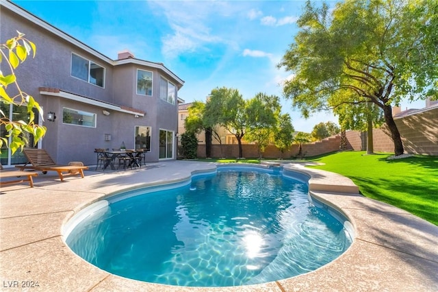 view of pool featuring a lawn and a patio area