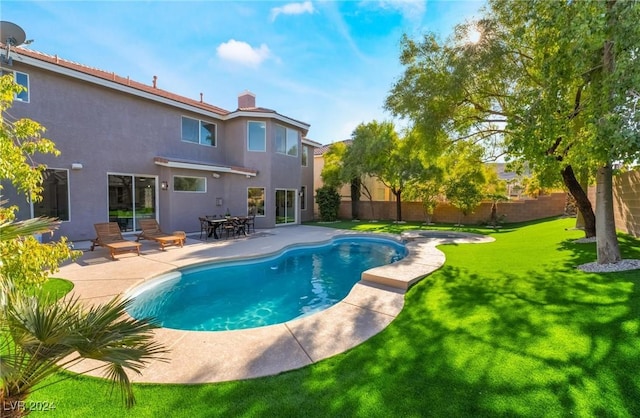 view of swimming pool with a yard and a patio