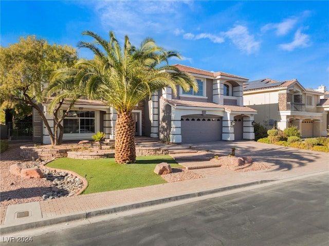 view of front of home featuring a garage and a front lawn