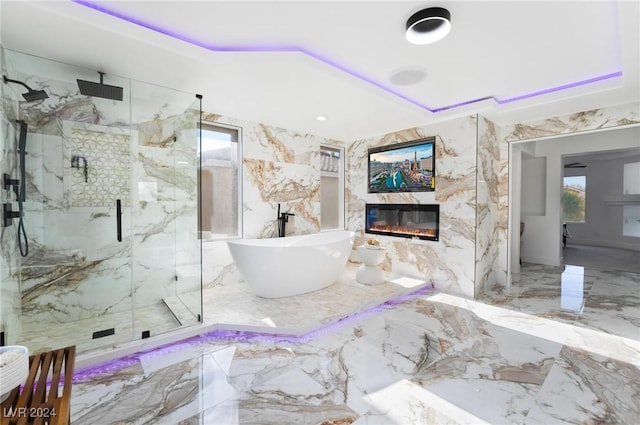 bathroom with a fireplace and independent shower and bath