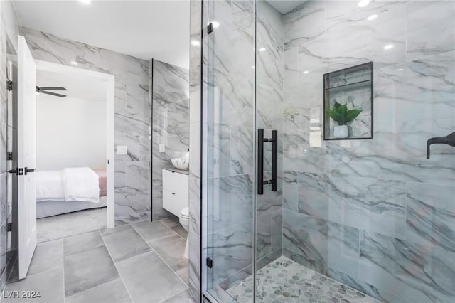 bathroom with an enclosed shower, toilet, and ceiling fan