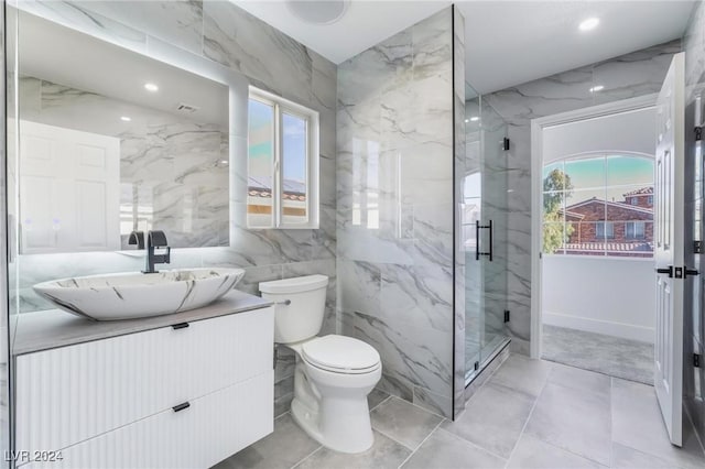 bathroom featuring vanity, toilet, tile walls, and a wealth of natural light