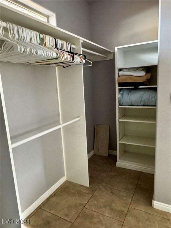 spacious closet with tile patterned floors