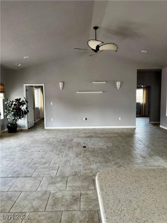 unfurnished room featuring ceiling fan and lofted ceiling