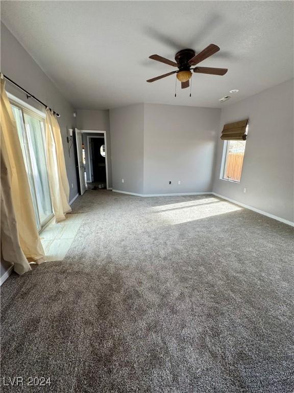 unfurnished room featuring light colored carpet and ceiling fan