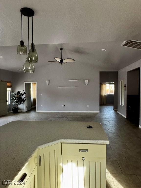 interior space featuring a textured ceiling and ceiling fan