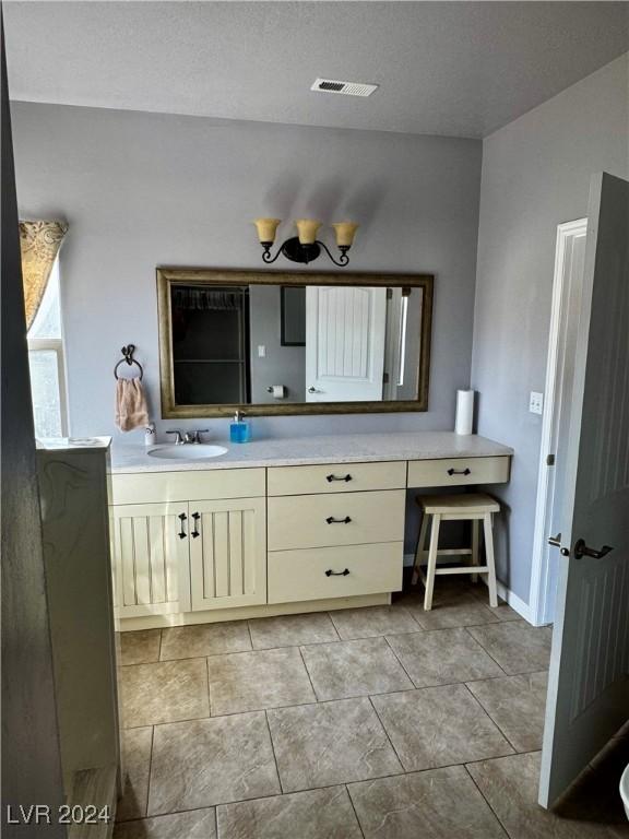 bathroom featuring vanity and a textured ceiling