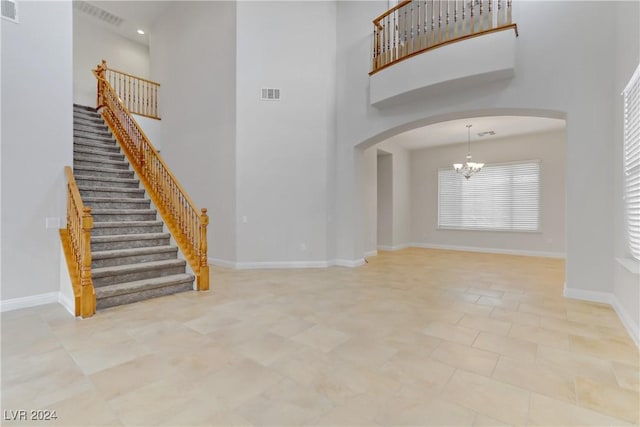 foyer with a chandelier and a high ceiling