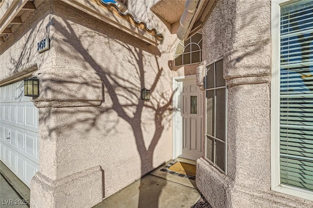 view of exterior entry with a garage