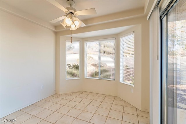 tiled spare room featuring ceiling fan