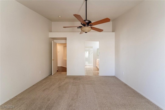 unfurnished bedroom featuring light carpet and ceiling fan