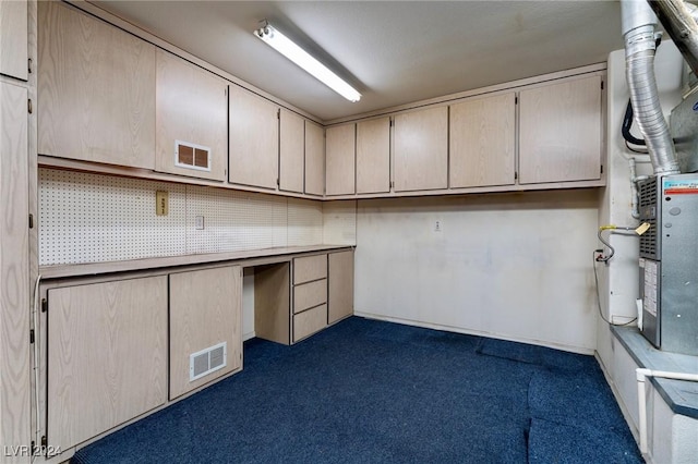 basement featuring heating unit and dark carpet