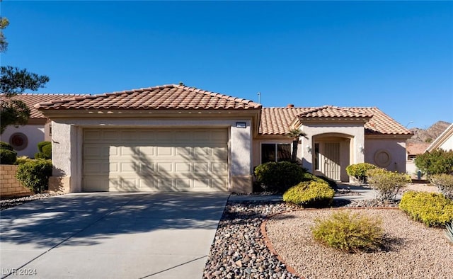 mediterranean / spanish-style home featuring a garage