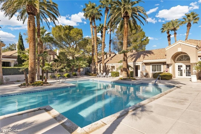 view of pool with a patio and french doors