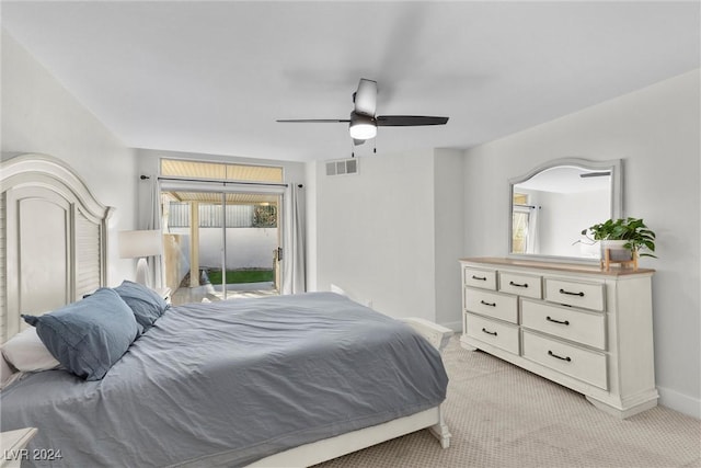 bedroom with access to outside, light colored carpet, and ceiling fan