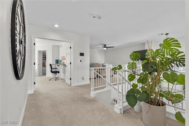 hallway featuring light carpet