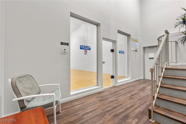 staircase with hardwood / wood-style floors