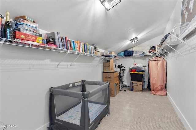 spacious closet featuring vaulted ceiling and carpet flooring