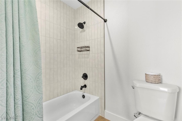 bathroom featuring shower / tub combo with curtain and toilet