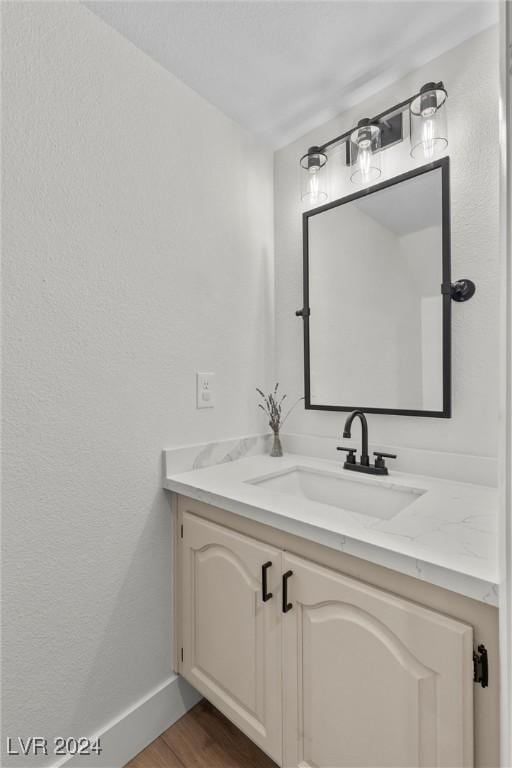 bathroom featuring vanity and hardwood / wood-style floors