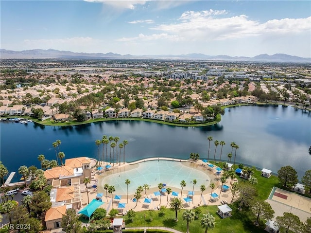 drone / aerial view with a water and mountain view