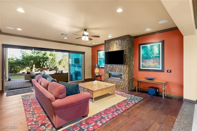 living room with a fireplace, wood-type flooring, ceiling fan, and ornamental molding