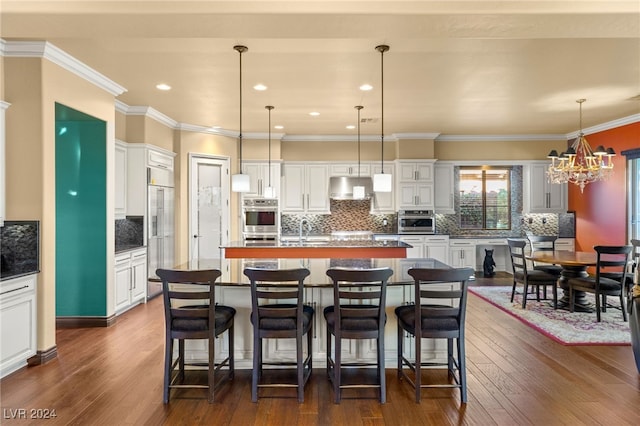 kitchen featuring a kitchen island, dark wood-type flooring, and hanging light fixtures