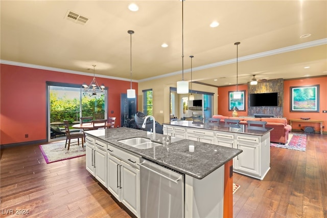 kitchen featuring white cabinetry, sink, dishwasher, a kitchen island with sink, and hardwood / wood-style flooring