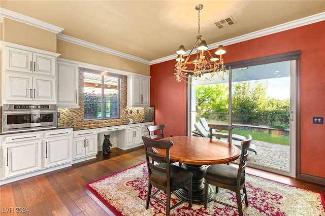 dining area with a notable chandelier, dark hardwood / wood-style floors, and ornamental molding