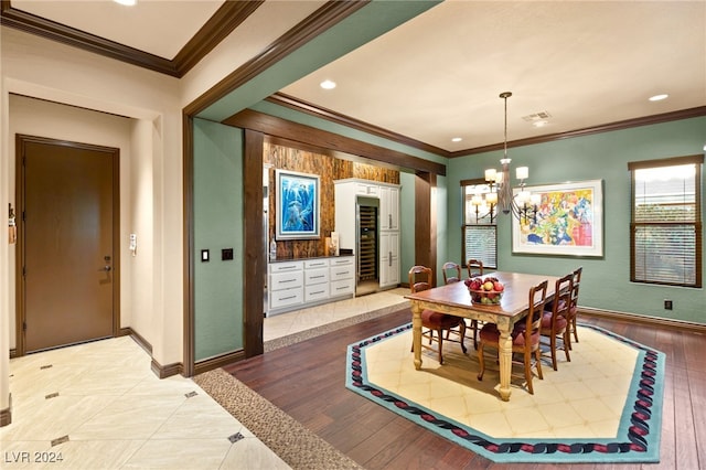 dining area featuring a chandelier, light hardwood / wood-style floors, and ornamental molding