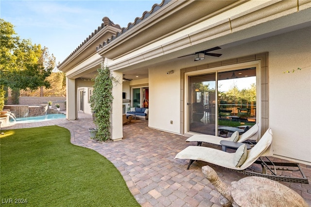 view of patio / terrace with pool water feature and ceiling fan