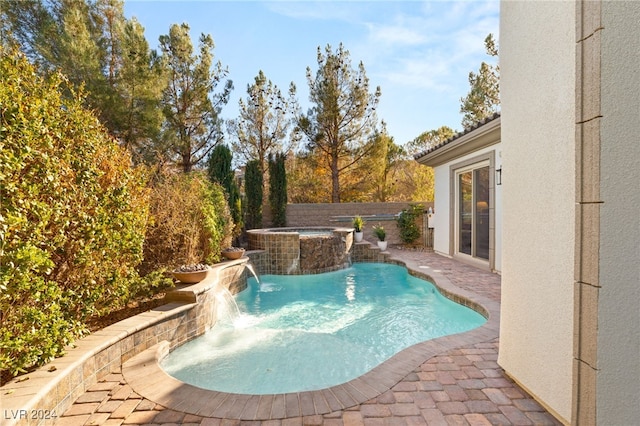 view of swimming pool featuring an in ground hot tub and pool water feature