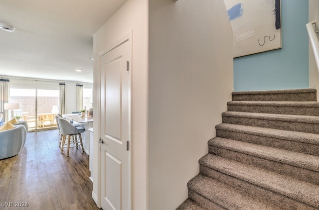 stairway featuring hardwood / wood-style flooring