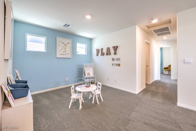 recreation room featuring dark carpet