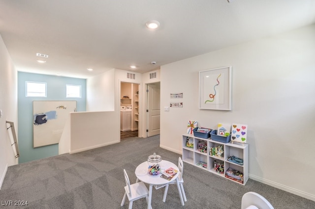 rec room featuring washer / dryer and carpet floors