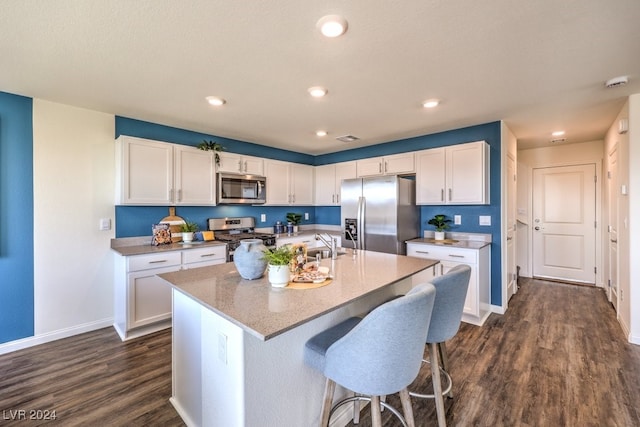 kitchen featuring white cabinets, dark hardwood / wood-style flooring, and stainless steel appliances