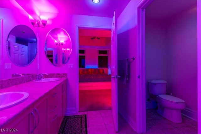 bathroom featuring toilet, vanity, and tile patterned flooring