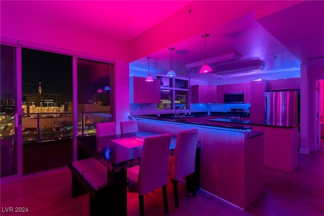 bar with refrigerator, sink, stainless steel stove, and pendant lighting