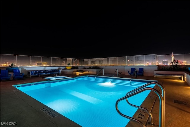 view of pool at twilight