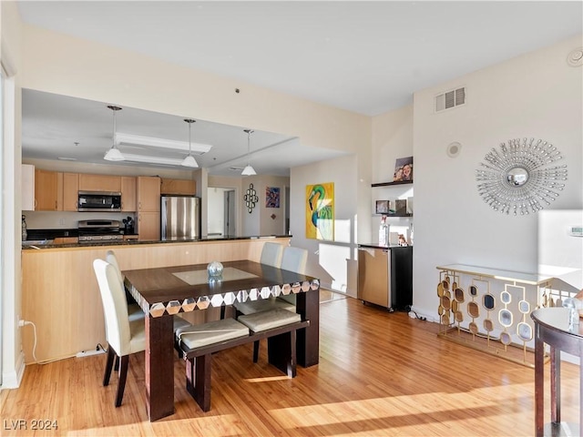 dining space with light hardwood / wood-style flooring