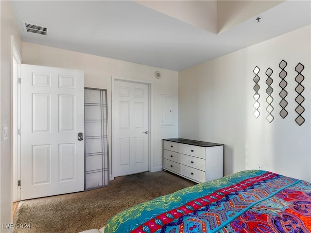 bedroom featuring dark carpet